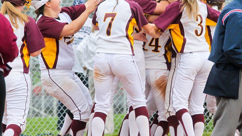 Layne Shields (14) is mobbed by her Ross teammates Tuesday after scoring in the 10th inning to beat visiting Edgewood 1-0. GREG LYNCH/STAFF