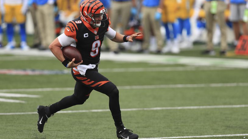 Cincinnati Bengals quarterback Joe Burrow (9) runs for a touchdown during the first half of an NFL football game against the Los Angeles Chargers, Sunday, Sept. 13, 2020, in Cincinnati. (AP Photo/Aaron Doster)