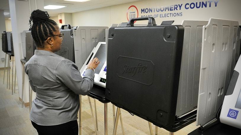 Inger Marsh looks over one of the polling machines at the Montgomery County Board of Elections on Wednesday March 24, 2022. MARSHALL GORBY\STAFF