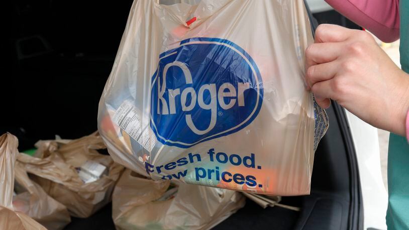 FILE - A customer removes her purchases at a Kroger grocery store in Flowood, Miss., Wednesday, June 26, 2019. Kroger and Albertsons are selling more than 400 stores and other assets to C&S Wholesale Grocers in an approximately $1.9 billion deal as part of their efforts to complete their merger, Friday, Sept. 8, 2023. (AP Photo/Rogelio V. Solis, File)
