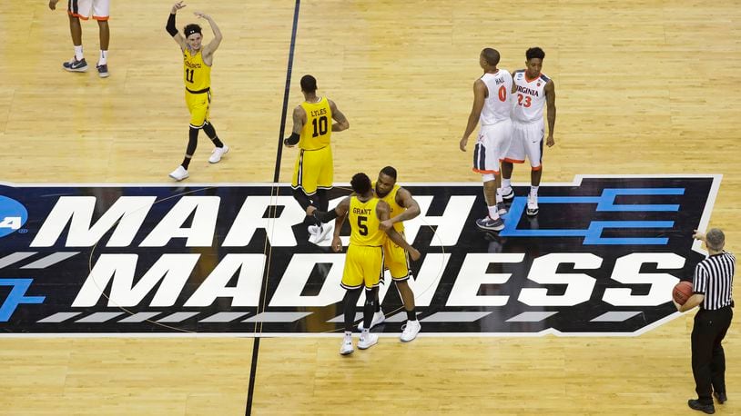 FILE - UMBC players celebrate their 74-54 win over Virginia in a first-round game in the NCAA men's college basketball tournament in Charlotte, N.C., March 16, 2018. Five years ago Thursday a tiny school few had ever heard of — and virtually no one gave an ounce of a chance to win — pulled off the biggest upset in NCAA Tournament history as University of Maryland-Baltimore County knocked off the tournament’s top overall seed, elevating March Madness to a whole new level. (AP Photo/Chuck Burton, File)