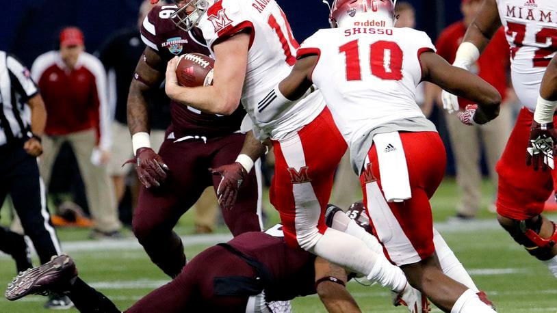 ST. PETERSBURG, FL - DECEMBER 26: Quarterback Gus Ragland #14 of the Miami (Oh) Redhawks tries to jump over a defender during a run in the first quarter against the Mississippi State Bulldogs in the St. Petersburg Bowl at Tropicana Field on December 26, 2016, in St. Petersburg, Florida. (Photo by Joseph Garnett, Jr. /Getty Images)