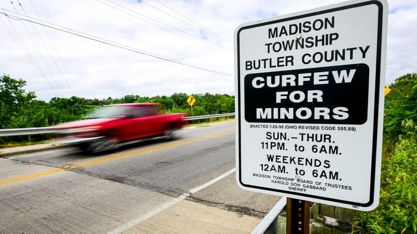A sign displaying curfew times for minors is on display along OH-122 entering Madison Township. Middletown police recently reminded people via Facebook about the city’s curfew for juveniles, which has been on the books for years. Middletown Police Chief Rodney Muterspaw said in recent years it has been enforced and admitted it is a rather old-fashion law, but a jump in juvenile arrests going into the summer and what officers are seeing on the street means the curfew laws will have more teeth this year. NICK GRAHAM/STAFF