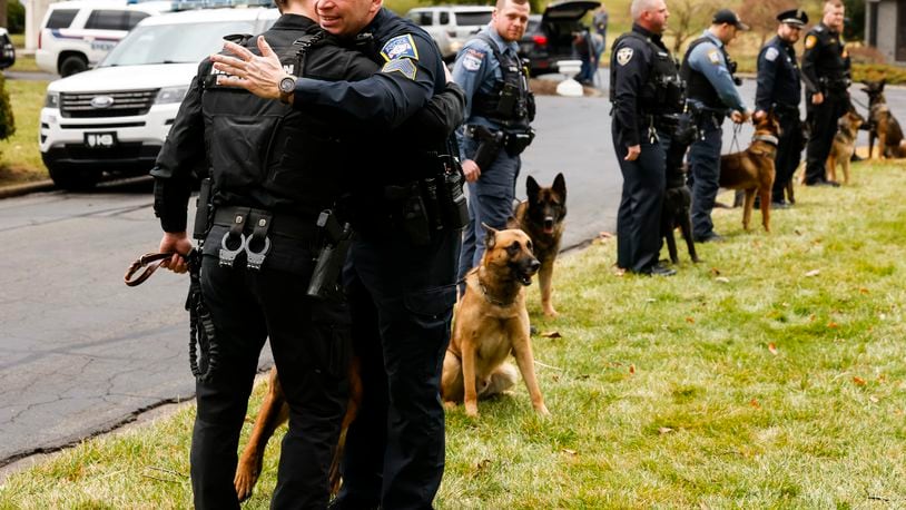 Middletown Police Sgt. Dennis Jordan, right, hugs fellow K9 handlers during a memorial ceremony held for Middletown Police K9 Koda, the partner of Sgt. Dennis Jordan, Thursday, Feb. 9. 2023 at the Middletown Firefighters and Police Officers Memorial at Woodside Cemetery in Middletown.

K9 Koda, a 7 1/2 year old Dutch shepherd from the Czech Republic, passed away early Sunday after a short bout with cancer. Koda began patrol 2017 where he served with Jordan for the last 6 1/2 years. NICK GRAHAM/STAFF