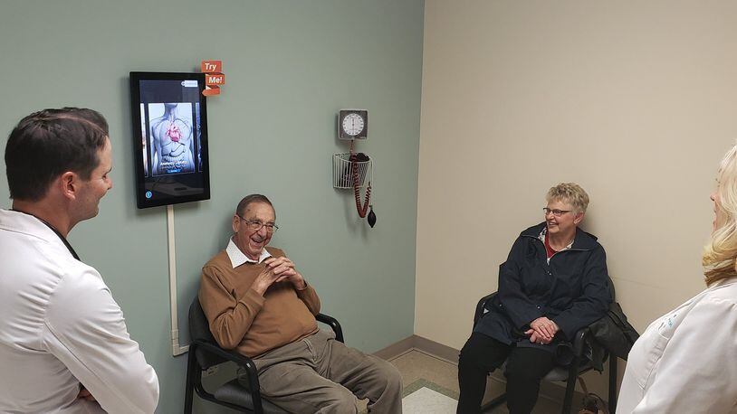 Dr. Daniel Eckert (left), a cardiologist with Mercy Health-The Heart Institute, and TAVR program coordinator Jami Heil (right) speak with Thomas and Philomena Banks during a follow-up appointment at Mercy Health-Fairfield Hospital Thursday, Dec. 19, 2019. Thomas Banks was the 300th person to undergo a transcatheter aortic valve replacement, or TAVR, a low-risk procedure that allows patients to be discharged within 24 hours, with complete recovery in less than a week. ERIC SCHWARTZBERG/STAFF