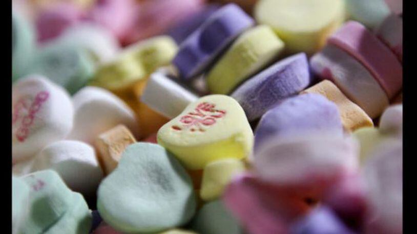 Multi-colored "Sweethearts" candy is held in bulk prior to packaging at the New England Confectionery Company in Revere, Mass. The company was sold to the Spangler Candy Co. on May 23, 2018.