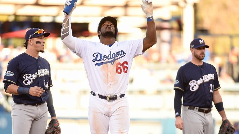 LOS ANGELES, CA - OCTOBER 17: Yasiel Puig #66 of the Los Angeles Dodgers reacts after hitting a double during the eighth inning against the Milwaukee Brewers in Game Five of the National League Championship Series at Dodger Stadium on October 17, 2018 in Los Angeles, California. (Photo by Kevork Djansezian/Getty Images)