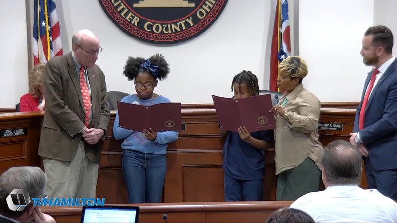Pictured in this screen capture from TVHamilton, are Kierra Wilson (center left) and Royal Lewis (center right), as they read a proclamation proclaiming February 2023 as Black History Month in the city of Hamilton. To the right of Royal is Booker T Washington Center Director Ebony Brock and Vice Mayor Michael Right. To the left of Kierra is Mayor Pat Moeller. PROVIDED BY TVHamilton