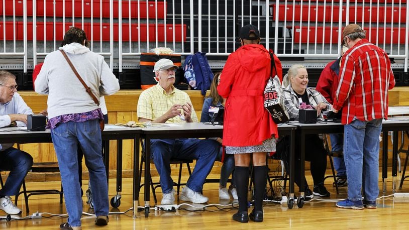 Butler County Board of Elections poll workers check in voters at Creekside Middle School Tuesday, May 3, 2022 in Fairfield. NICK GRAHAM/STAFF