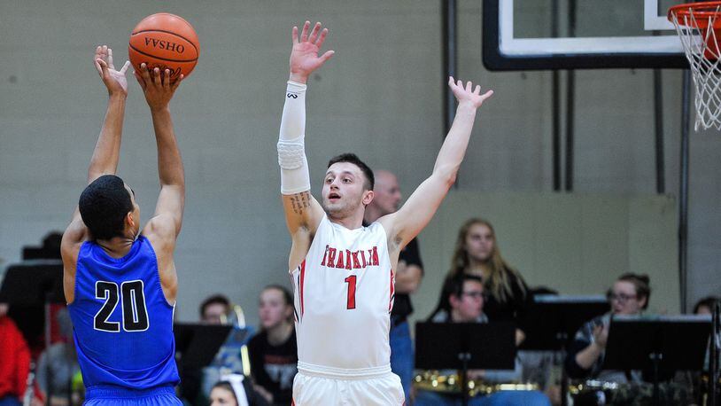 Franklin’s Brayden Hall goes after a shot by Brookville’s Manny Willis during Friday night’s game at Darrell Hedric Gym in Franklin. The host Wildcats won 72-68 in overtime. NICK GRAHAM/STAFF