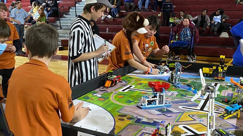 The Ross Schools’ tradition of student-produced robots battling and besting others will be tested as the district’s robotics team hosts a competition later this month. The top-rated academic school system in Butler County has for years also had a reputation for the successes of its student robotics squads, which often dominate other student teams in the region. Pictured are Ross students and their robot creations competing in last year’s competition. CONTRIBUTED