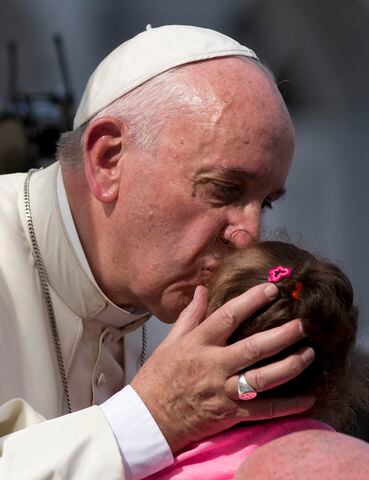 Pope embraces children