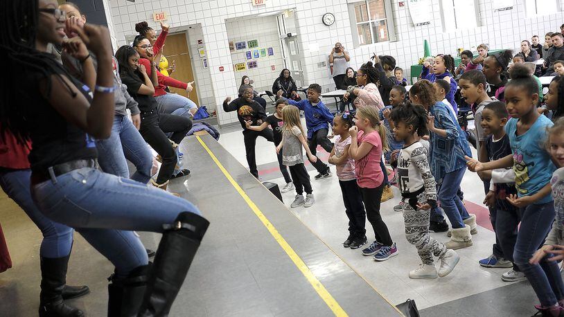 Children in the Lincoln Elementary Promise Neighborhood program try to keep up with a group of Wilberforce University fraternity and sorority members demonstrating “Step Dancing” Wednesday. Bill Lackey/Staff