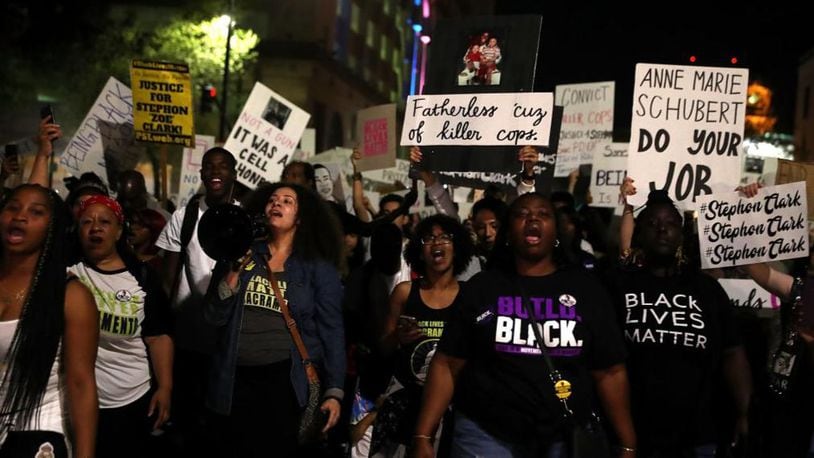 Citizens carried signs during a vigil for Stephon Clark.