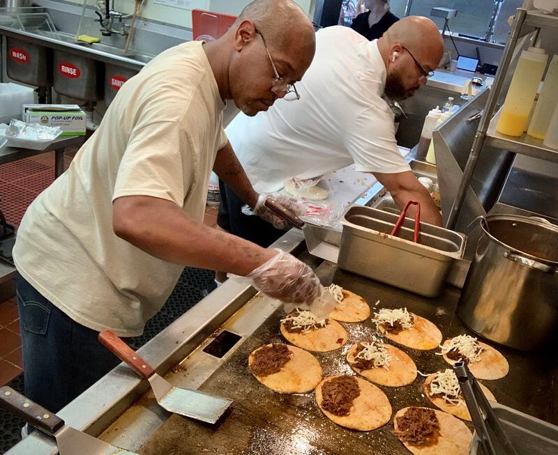 Taco Street Co, Kitchen Manager, Duane Walker, left, and owner, Anthony Thomas prepare Birria Tacos. MARSHALL GORBYSTAFF