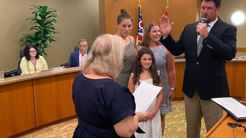 Adam Kraft is sworn in on Monday, August 8, 2022, as the newest member of Fairfield City Council. He was sworn in as the city’s Fourth Ward representative. He was accompanied by his family, to his right, which included (counter clockwise) his wife Tracy, and daughters Becca, 15, and Haylee, 9. Fairfield Municipal Court Judge Joyce Campbell (across from Kraft) administered the oath of office. MICHAEL D. PITMAN/STAFF