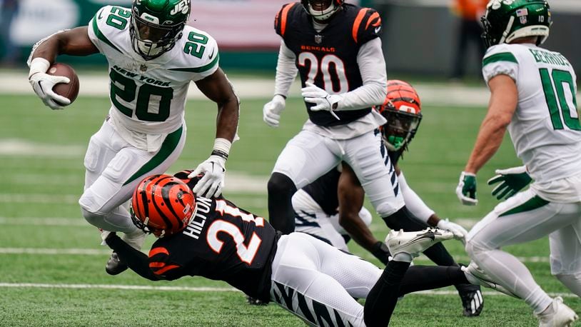 Cincinnati Bengals' Mike Hilton (21) tackles New York Jets' Breece Hall (20) during the first half of an NFL football game Sunday, Sept. 25, 2022, in East Rutherford, N.J. (AP Photo/Seth Wenig)