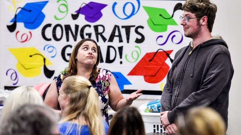 Two Butler County departments, Children Services and Developmental Disabilities have made strides in recent years, both fiscally and in dealing with the rampant opioid epidemic. Pictured here is case worker Amanda Hinkle as she congratulates Tyler Holt on his graduation during the annual Butler County Children Services graduation ceremony. NICK GRAHAM/STAFF