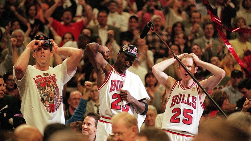 I3 Jun 1997:  Michael Jordan #23 of the Chicago Bulls celebrates with teammates Jud Buechler and Steve Kerr #25 after winning game six of the NBA Final against the Utah Jazz at the United Center in Chicago, Illinois. The Bulls defeated the Jazz 90-86..   Mandatory Credit: Jonathan Daniel  /Allsport