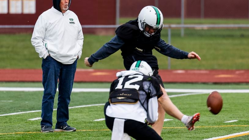 Alex Ritzie holds for kicker Jackson Niesen as assistant coach Dean Wright works with the kicking team during practice Wednesday, Dec. 1, 2021 at Ross High School. The Rams play Chardon Friday in the state championship game in Akron. NICK GRAHAM / STAFF