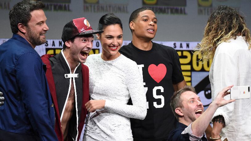 Moderator Chris Hardwick, foreground right, takes a selfie with from left, Ben Affleck, Ezra Miller, Gal Gadot, and Ray Fisher at the Warner Bros. "Justice League" panel on day three of Comic-Con International on Saturday, July 22, 2017, in San Diego. (Photo by Richard Shotwell/Invision/AP)