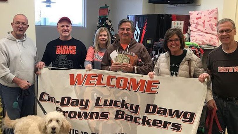 The Cin-Day Lucky Dawg Browns Backers of Mason have a “swear jar” into which members make a financial “donation” whenever they cuss while watching Browns games at the club’s Lucky Dog Grille headquarters in Mason. In all those losing years of the past, that jar – said Kurt Boveington (pictured on right), president of the club since 2011 – would be filled every week. At the end of each season the club donates the money and a truckload of dogfood to a local animal shelter. Pictured here are (left to right) are Bill Mahlock, Greg Soltis, Patty Soltis, Danny Dunn, Jodie Dunn and Boveington dropping off donations at The Animal Friends Shelter in Hamilton. CONTRIBUTED
