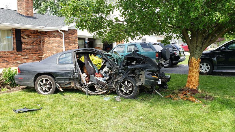 Neighbors say a car that slammed into a tree in the front yard of 860 North Garver Road in Monroe Sunday, May 26, 2019, is just the latest in a series of vehicles that routinely speed down the rural roadway. The crash injured two people, both of whom were taken to Atrium Medical Center. ERIC SCHWARTZBERG/STAFF