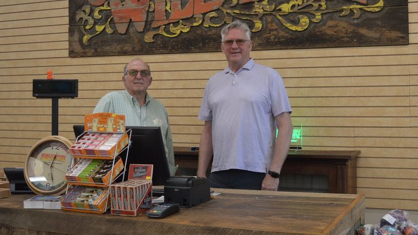 Wild Berry business owners Marc Biales (left) and Roger Atkin are shown behind the counter in their new incense store at 5465 College Corner Pike, in front of the incense factory. The store is open to the public but is also set up with all of their incense displays so potential vendors can see how they look in operation. CONTRIBUTED/BOB RATTERMAN