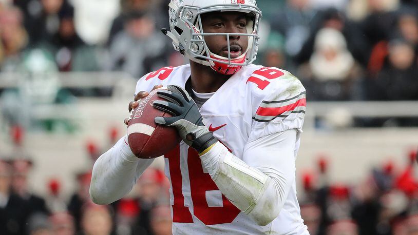 EAST LANSING, MI - NOVEMBER 19: J.T. Barrett #16 of the Ohio State Buckeyes drops back to pass during the fourth quarter of the game against the Michigan State Spartans at Spartan Stadium on November 19, 2016 in East Lansing, Michigan. Ohio State defeated Michigan State 17-16. (Photo by Leon Halip/Getty Images)