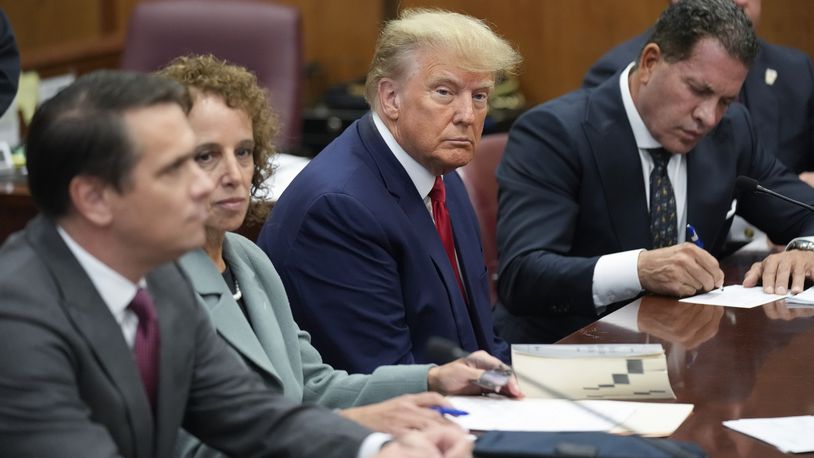 FILE - Former President Donald Trump sits at the defense table with his legal team in a Manhattan court, Tuesday, April 4, 2023, in New York. The first-ever trial of a former U.S. president will feature allegations that Trump falsified business records while compensating one of his lawyers, Michael Cohen, for burying stories about extramarital affairs that arose during the 2016 presidential race.(AP Photo/Seth Wenig, Pool)