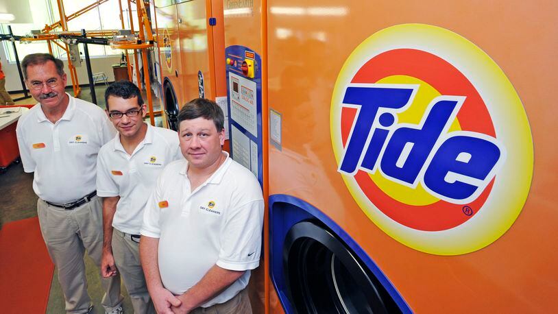 Tide Dry cleaners opened in Liberty Twp. on July 27. It is Tide’s first franchise location owned by former P&G employee Ray D’Alonzo (left). D’Alonzo stands with his son, Dominic, and his son-in-law Rick DeAngelis, who will help him run the store.