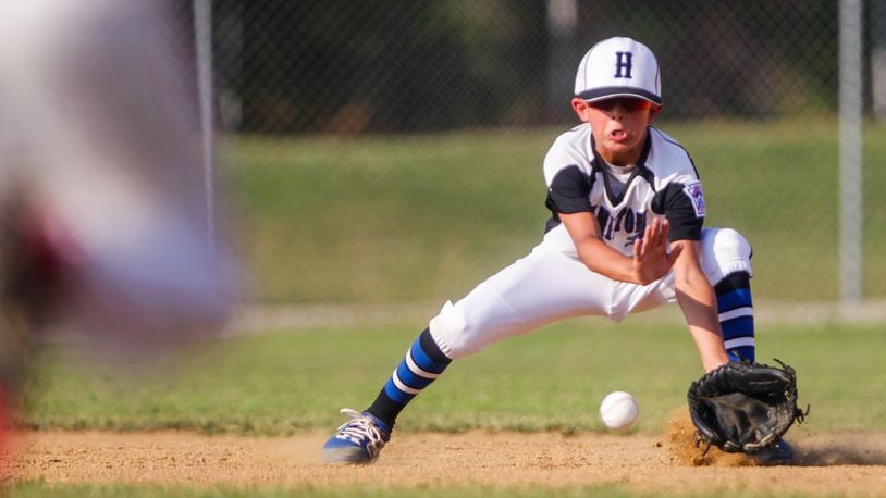 Hamilton West Side Little League’s Eli Wolpert fields a grounder and throws for an out at first during their Ohio District 9 Little League Championship win over Anderson Township Wednesday, July 10, 2019, at the West Side Little League complex in Hamilton. West Side Little League won 17-0. NICK GRAHAM/STAFF