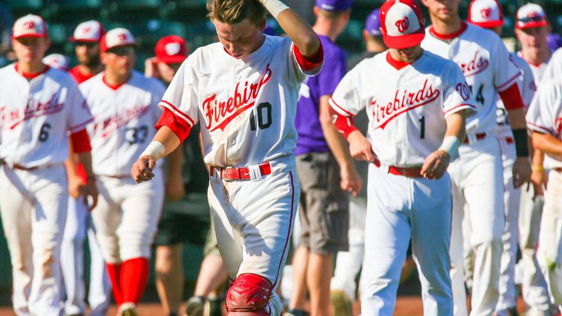 Chase Wullenweber (10) walks off the field with his Lakota West teammates Friday after losing to Massillon Jackson 5-1 in a Division I state semifinal at Huntington Park in Columbus. GREG LYNCH/STAFF