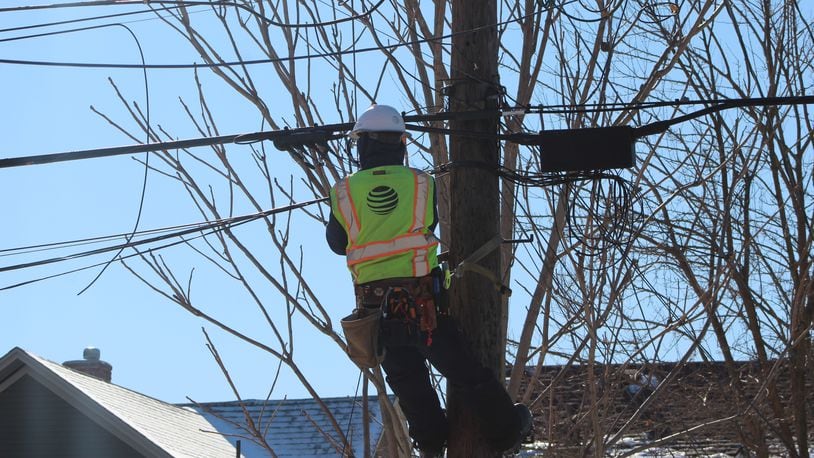 A technician with AT&T works on lines in Dayton. CORNELIUS FROLIK / STAFF