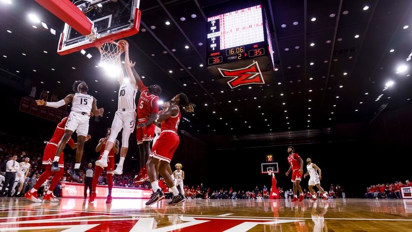 University of Cincinnati's Vikto Lakhin goes up for a dunk defended by Miami University's Precious Ayah during their basketball game during their basketball game Wednesday, Dec. 1, 2021 at Millett Hall on Miami University campus in Oxford. University of Cincinnati won 59-58. NICK GRAHAM / STAFF