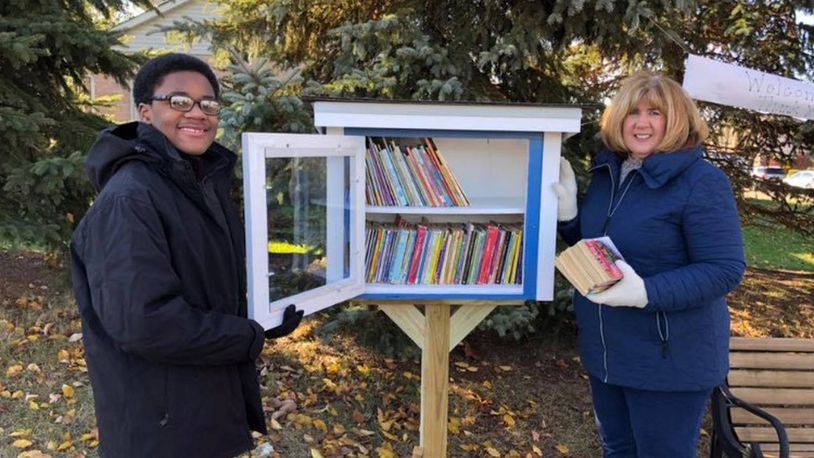 Mason Middle School eighth grader Joseph Washington and retired Mason teacher Gayle Ertel opened Little Library #1 on Nov. 10 at the corner of Tylersville Road and Foxfield Drive. CONTRIBUTED