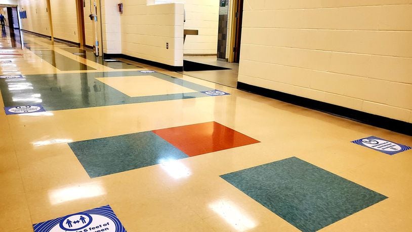 Like many area schools, Hamilton High School is dotted with warning signs regarding coronavirus precautions as students return to the city school district Monday. The impacts of coronavirus safety protocols are deep and widespread, say local school officials. (Provided Photo\Journal-News)