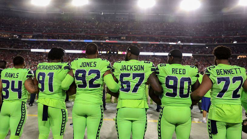 Running back Thomas Rawls #34, defensive tackle Sheldon Richardson #91, defensive tackle Nazair Jones #92, defensive end Branden Jackson #67, defensive tackle Jarran Reed #90 and defensive end Michael Bennett #72 of the Seattle Seahawks stand during the national anthem for the NFL game against the Arizona Cardinals at University of Phoenix Stadium on November 9, 2017 in Glendale, Arizona.  (Photo by Christian Petersen/Getty Images)