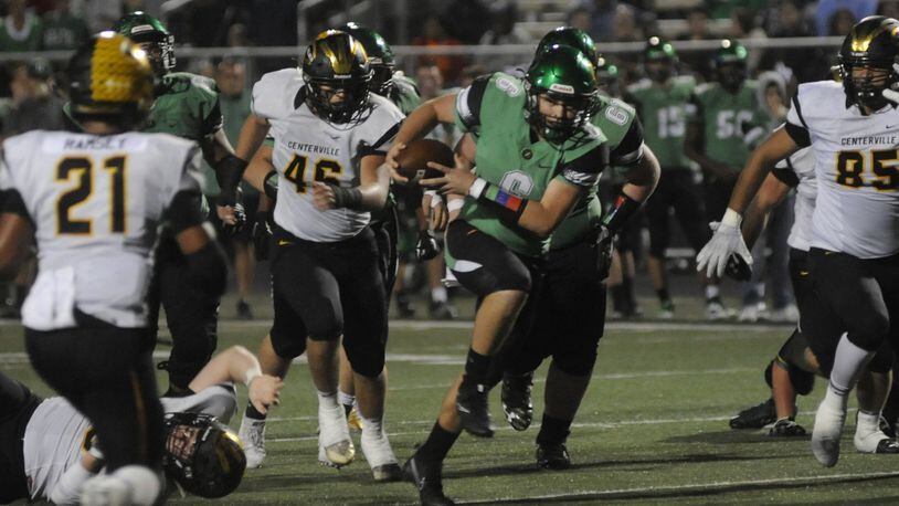Northmont QB Miles Johnson is pursued by Centerville’s Dom Ramsey (21), Jake Snead (45) and Jevon Henderson. Northmont defeated visiting and previously unbeaten Centerville 21-14 in a Week 8 GWOC crossover high school football game on Friday, Oct. 13, 2017. MARC PENDLETON / STAFF