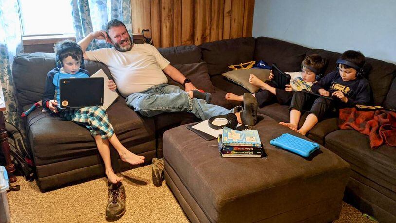 It’s shoes and socks optional learning at home for the Farler family and thousands of other area school families who are staying home under preventive measures to bind the spread of the Coronavirus. The Talawanda family say the subsequent togetherness has many benefits - here Andy Farler oversees his children’s digital learning and activities - and a few challenges. (Provided Photo/Journal-News)
