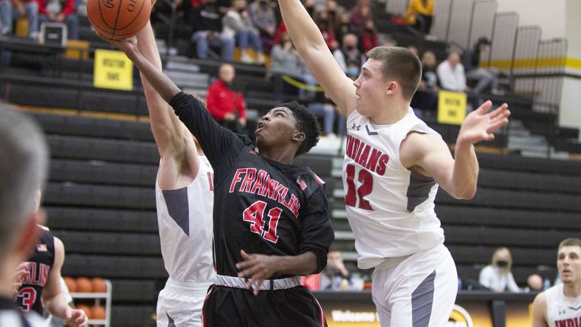 Franklin's Tez Lattimore tries to score against Stebbins' Nate Keller in a Division I sectional game Saturday at Centerville. Franklin advanced with a 71-65 victory. Jeff Gilbert/CONTRIBUTED