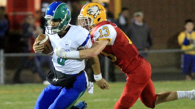 Chaminade Julienne quarterback Jacob Harrison is brought down by Fenwick’s Luke Sennett during a game at Krusling Field in Middletown on Oct. 24, 2014. CONTRIBUTED PHOTO BY E.L. HUBBARD