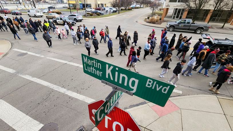 Rev. Victor Davis led a Martin Luther King Jr. Day march Monday, Jan. 16, 2023 in Hamilton. A large group marched from Booker T. Washington Community Center to High Street to Martin Luther King Jr. Blvd. and ended at House of Deliverance on S 2nd Street for a program with special guest speakers.  NICK GRAHAM / STAFF