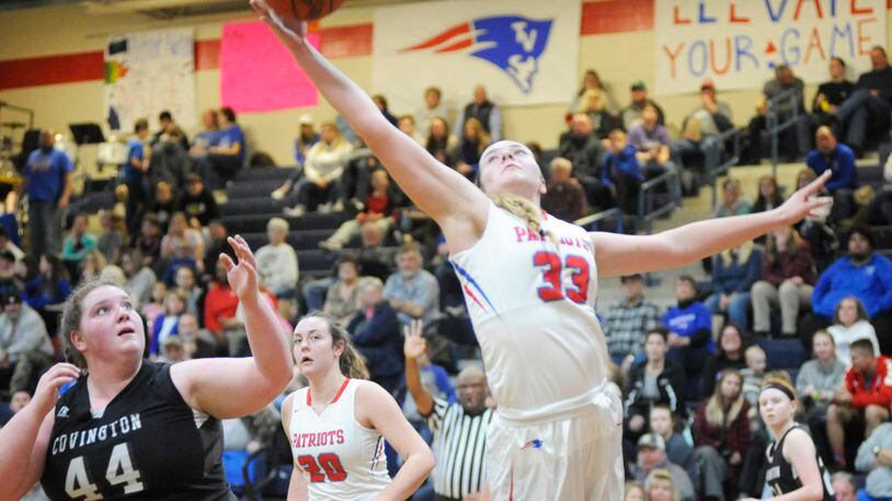 Maddie Downing of Tri-Village snaps a rebound away from Covington s Lauren Christian. Tri-Village defeated visiting Covington 44-35 in a girls high school basketball game on Thursday, Jan. 10, 2019. MARC PENDLETON / STAFF