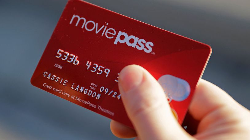 In this Jan. 30, 2018, file photo, Cassie Langdon holds her MoviePass card outside AMC Indianapolis 17 theatre in Indianapolis. MoviePass, the discount service for movie tickets, is raising prices by 50 percent and barring viewings of most major releases during the first two weeks. (AP Photo/Darron Cummings, File)