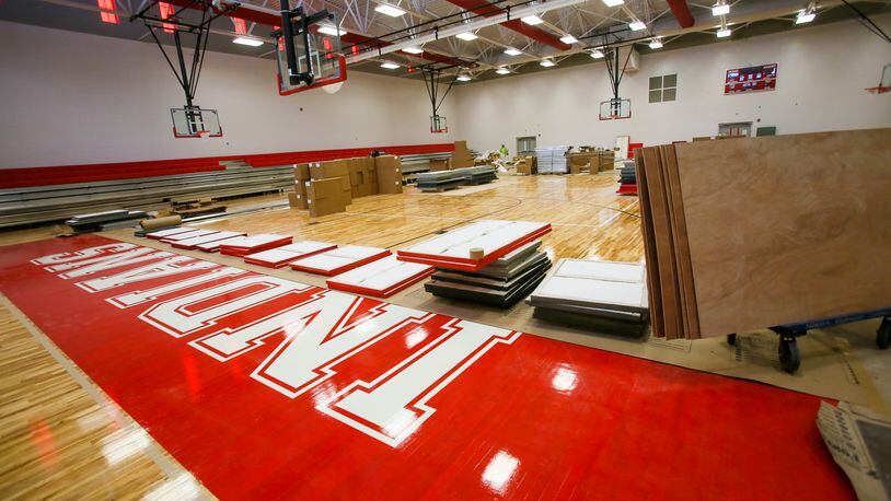 Crews work in June on the basketball court at the new Fairfield Freshman School. GREG LYNCH / STAFF