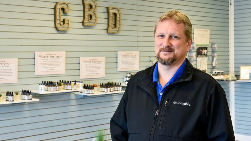 Jeff Butterfield stands inside his Your CBD Store he recently opened in Fairfield. Butterfield was one of many businesses in the area who were given letters by the Butler County General Health District to shut down operations stating they are not an essential business during the novel coronavirus pandemic. NICK GRAHAM /STAFF