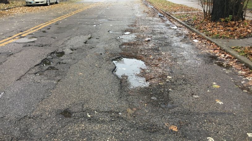 Plentiful potholes can be seen on Ludlow Street in Hamilton. City residents in May will be asked to approve a street-repair levy to help eliminate the problem.
