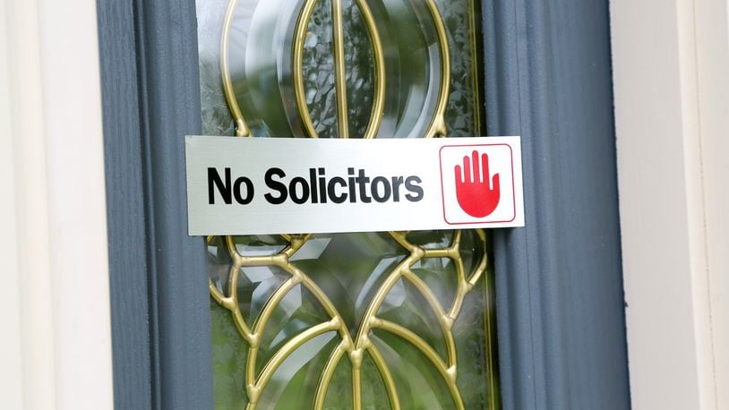 A “No Solicitors” sign on the front door of a home in the Logsdon’s Ridge subdivision in Liberty Twp. GREG LYNCH / STAFF