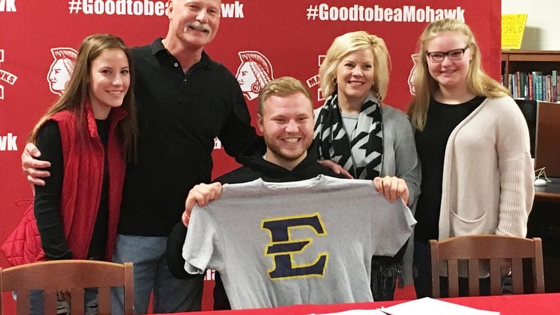 Madison’s Max Evans poses with his family — from left, Carly, Greg, Julie and Stella Evans — during Friday’s signing ceremony in the high school media center. Evans will continue his football career at East Tennessee State University. RICK CASSANO/STAFF